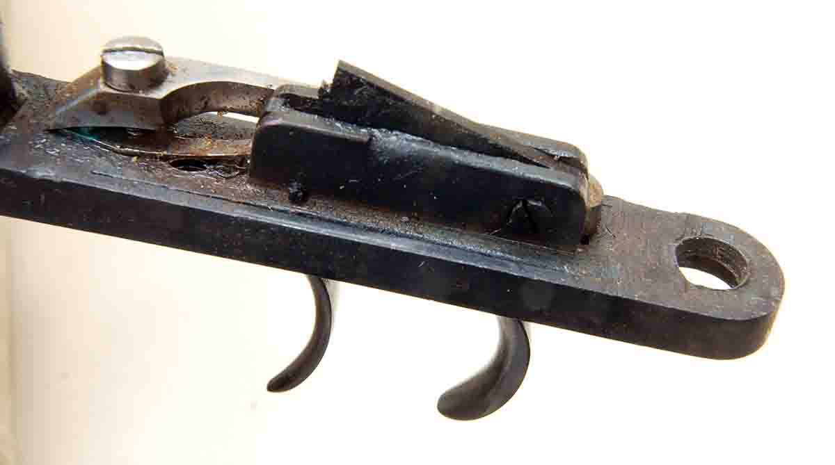 A dirt and rust-coated set trigger mechanism of a recently disassembled rifle.